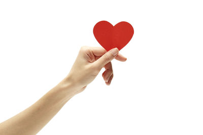 Midsection of woman holding heart shape against white background
