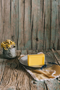 Close-up of yellow flowers in bowl on table