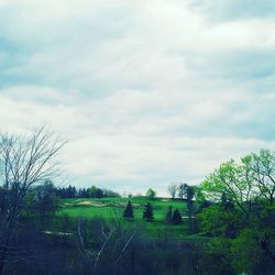 Scenic view of field against cloudy sky