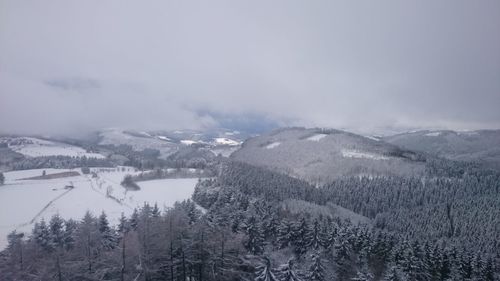 Scenic view of snow covered mountains against sky