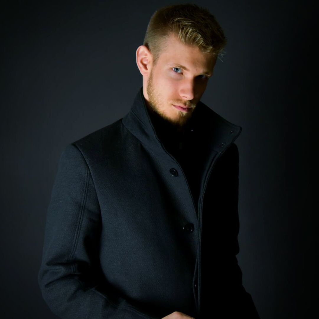 studio shot, portrait, one person, black background, looking at camera, young adult, confidence, suit, standing, people