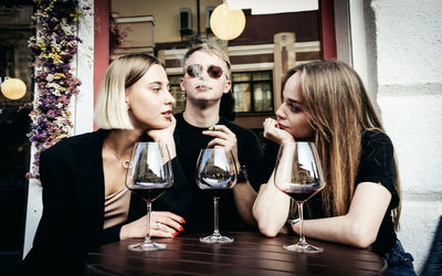 Young woman drinking glasses on table