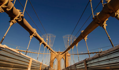 Low angle view of bridge against clear blue sky