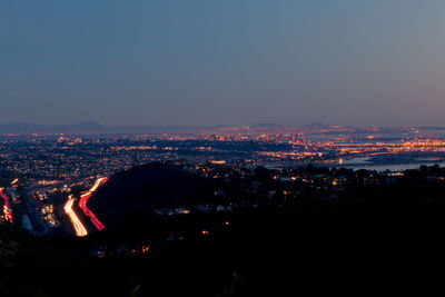 High angle view of illuminated buildings in city at night
