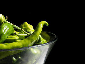 Close-up of green chili peppers in bowl on table