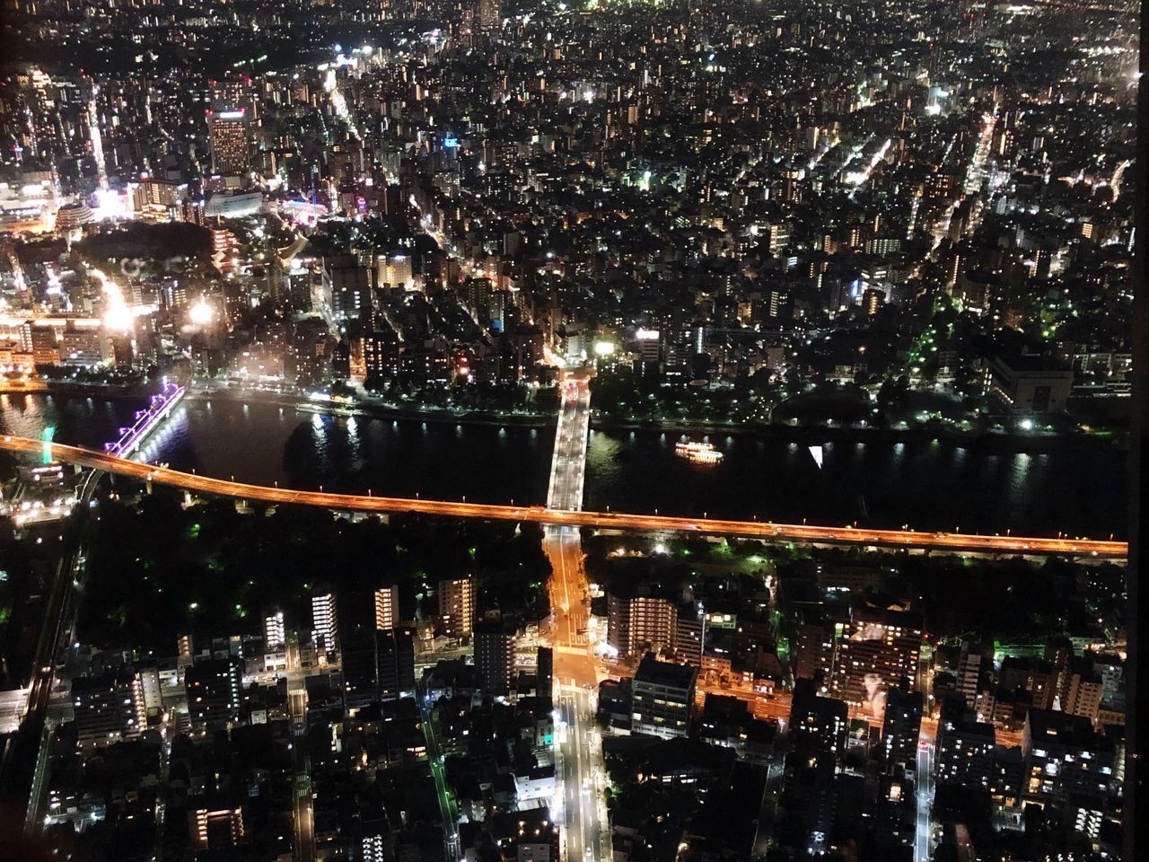 ILLUMINATED BUILDINGS IN CITY AT NIGHT