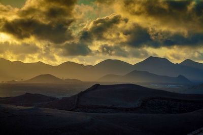 Scenic view of mountains against sky at sunset