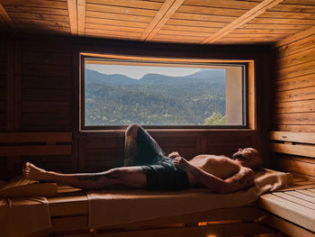 Man laying down in a sauna