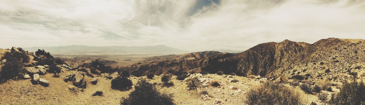 sky, tranquil scene, tranquility, scenics, landscape, sand, mountain, beauty in nature, nature, cloud - sky, arid climate, desert, cloud, non-urban scene, rock formation, remote, physical geography, idyllic, geology, day