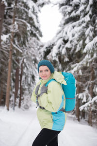 Portrait of woman standing in snow