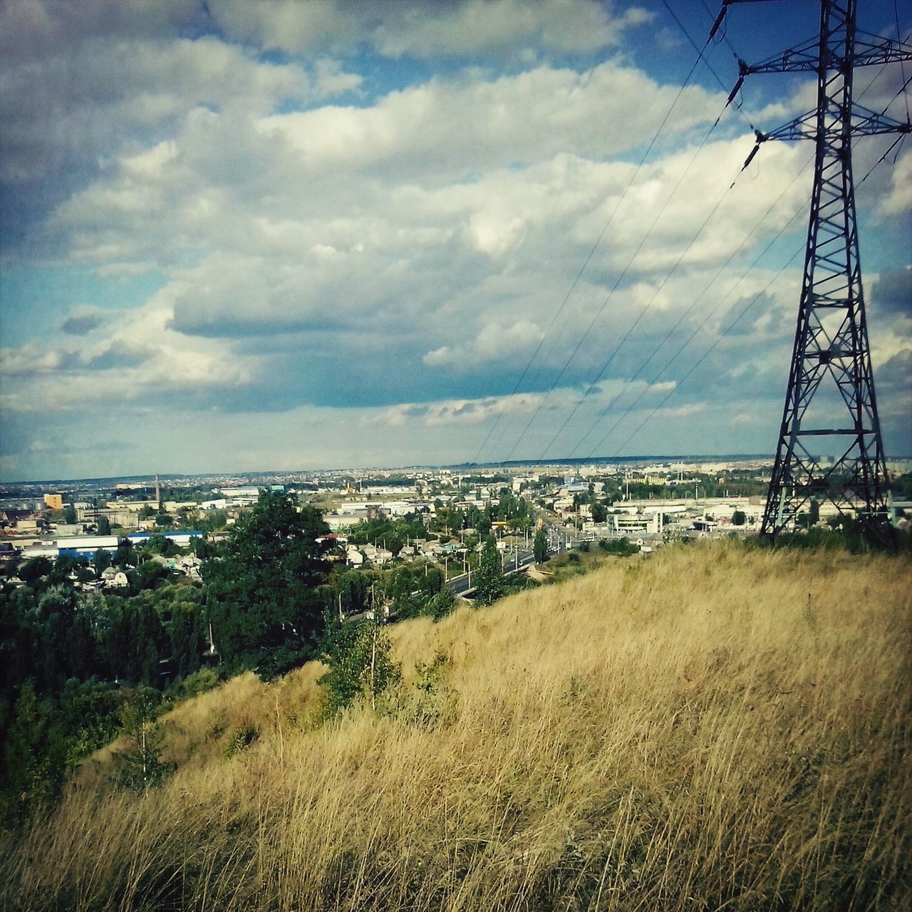 sky, cloud - sky, built structure, building exterior, cloudy, electricity pylon, architecture, cloud, water, power line, field, nature, connection, electricity, day, landscape, grass, outdoors, city, no people