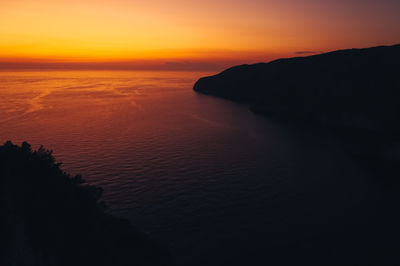 Fiery sky as the sunset over a bay in zakynthos, greece