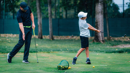 Boy playing with ball on grass