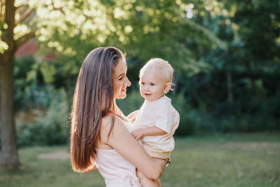 Mother and son standing at park