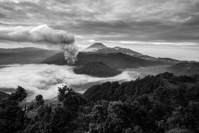 View of volcanic landscape against cloudy sky