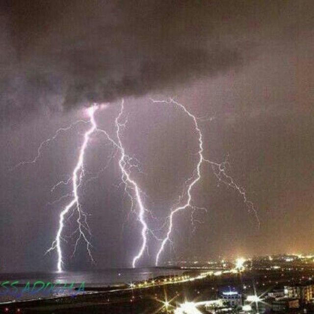 night, illuminated, sky, power in nature, lightning, thunderstorm, long exposure, storm, cloud - sky, scenics, storm cloud, water, city, rainbow, motion, nature, beauty in nature, weather, built structure, forked lightning