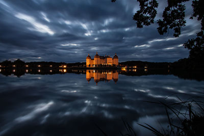 Reflection of buildings in lake at dusk