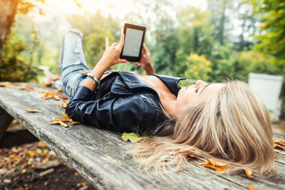 Midsection of woman using mobile phone outdoors