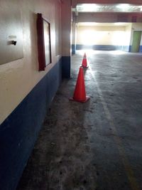 Red umbrella on illuminated corridor of building