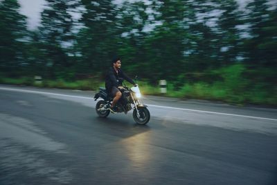 Man riding motorcycle on road