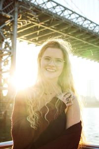 Portrait of smiling young woman standing outdoors