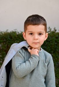 Portrait of cute boy standing outdoors