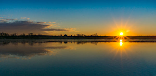 Scenic view of sunset over river