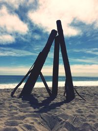 Lifeguard hut on beach against sky