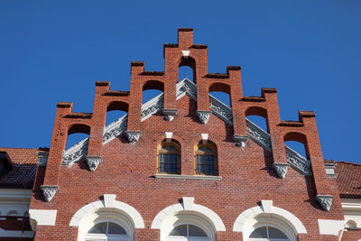 Low angle view of building against clear blue sky