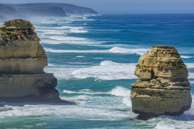 Rock formation in sea against sky