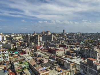 Cityscape against cloudy sky