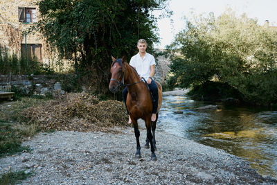 Full length of woman riding horse