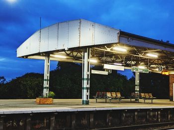 Low angle view of illuminated built structure against blue sky