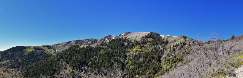 Scenic view of mountains against clear blue sky