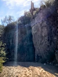 Scenic view of waterfall against sky
