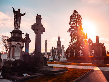 Statue of historic building against sky during sunset