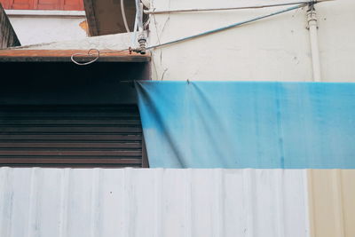 Close-up of white building against blue wall