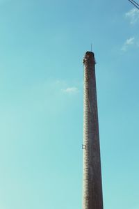 Low angle view of tower against blue sky