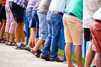 Low section of people standing on street