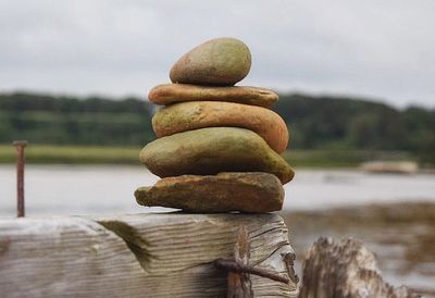 Close-up of stack of wooden post in water