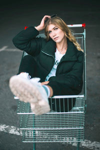 Portrait of young woman sitting outdoors