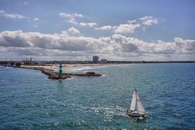 Sailboat sailing on sea against sky