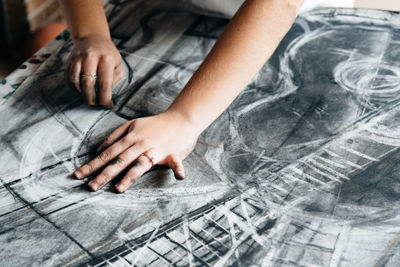 Close-up of hands working on table