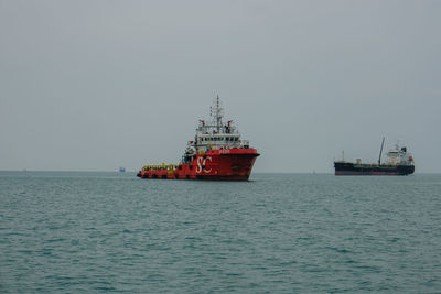 Ship sailing on sea against clear sky