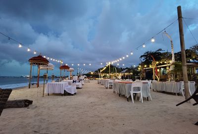 Scenic view of beach against sky at sunset