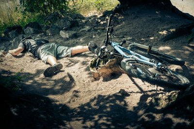 High angle view of man lying on bicycle