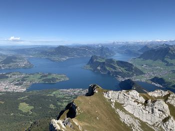 High angle view of lake and mountains against sky