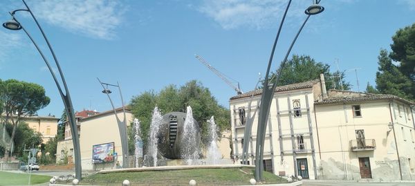 Panoramic view of buildings and street against sky