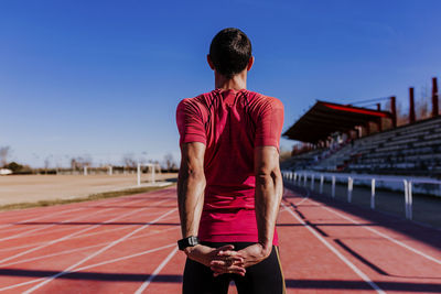 Rear view of man standing against sky