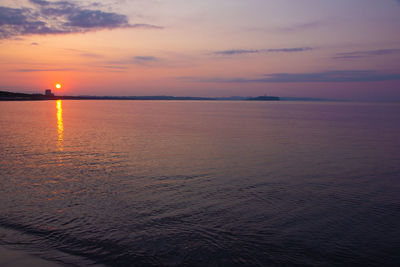 Scenic view of sea against romantic sky at sunset